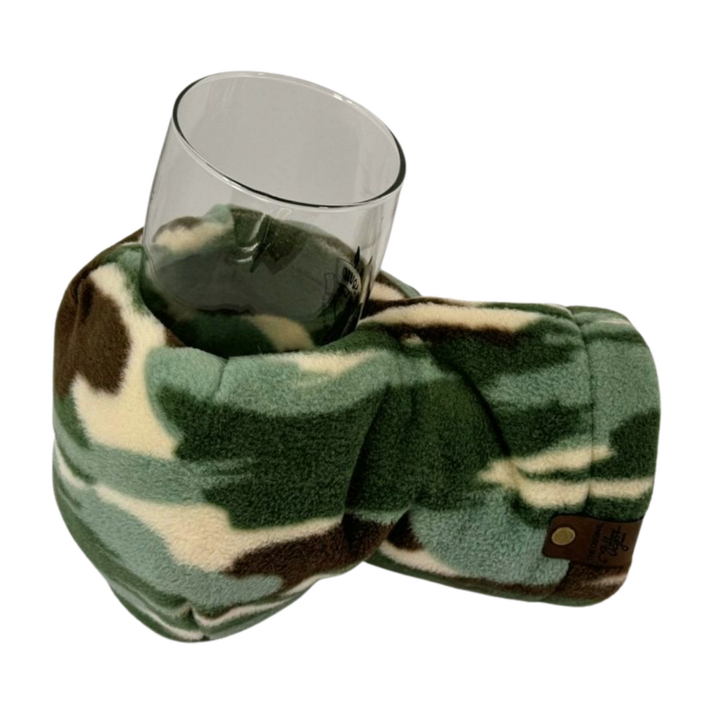 Camouflage Giddyup Glove™ holding a glass, ergonomic and no-grip needed for cozy outdoor sipping.