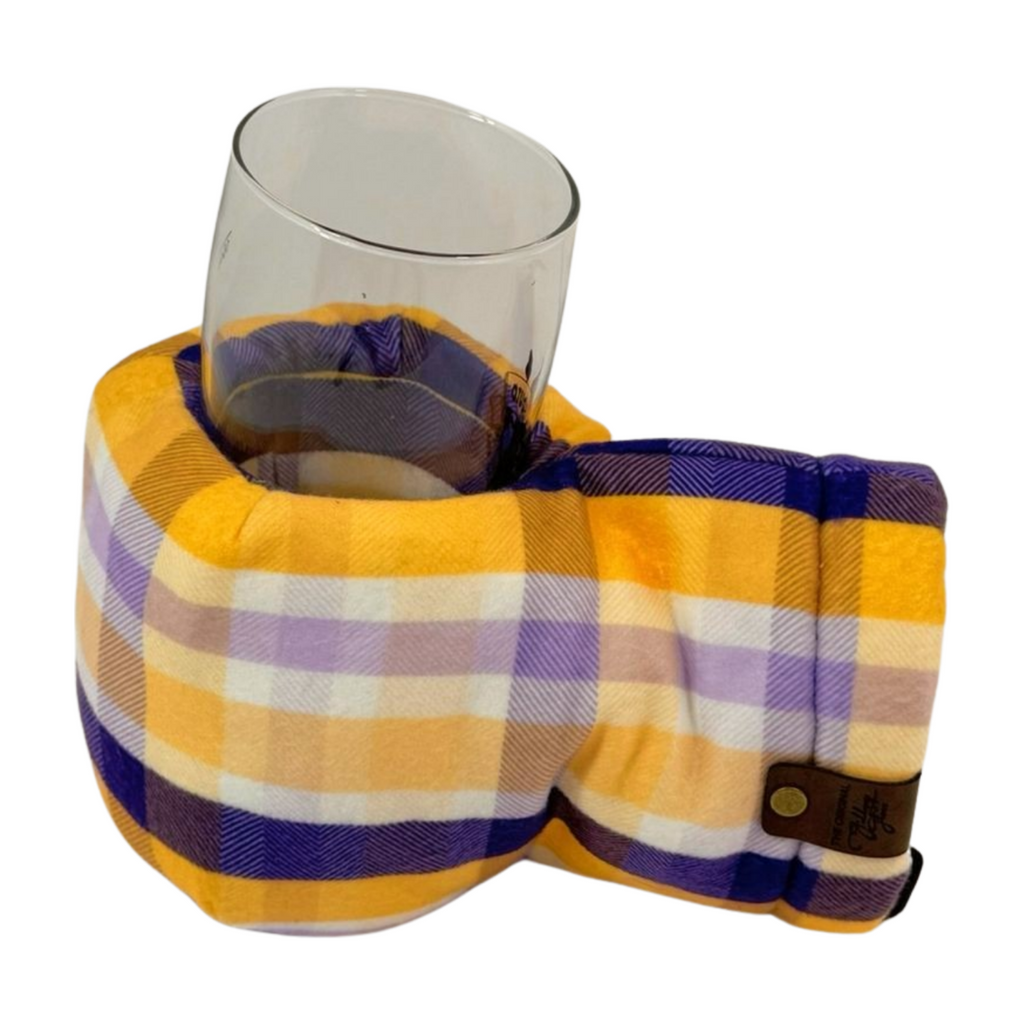 Winter Sunset Purple Gold Plaid Giddyup Glove™ holding a glass, stylish and functional winter mitten.